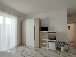 a white room with a refrigerator and a tv at BlaBla Casa Mia in Modugno