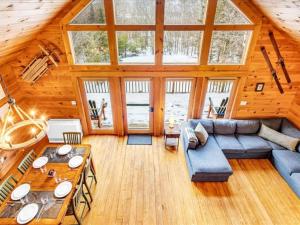 a living room with a couch and a table at Gorgeous Chalet! VIEWS! Hot Tub! Sleeps 12! Games in Bethel