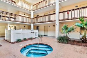 a large building with a swimming pool in a courtyard at Beachside Retreat-Courtyard Villa-Beachside condo in Saint Augustine Beach +38 photos