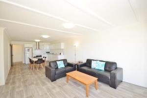 a living room with a couch and a table at Kalbarri Waters A - Kalbarri WA in Kalbarri