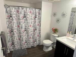 a bathroom with a toilet and a shower curtain at Incredible Hollywood Loft Free Parking in Los Angeles
