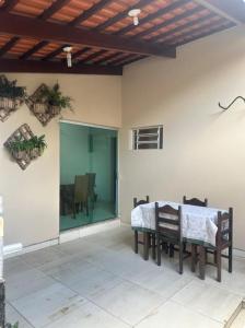 a dining room with a table and chairs on a patio at Casa aconchegante no centro in Divinópolis