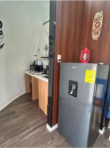 a kitchen with a refrigerator and a counter at Iglú Popeye a 6 minutos de la paya in Barra de Navidad