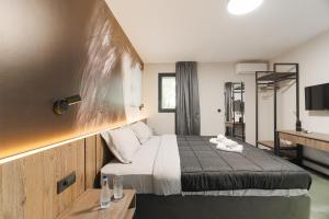a hotel room with a bed and a desk at Solis Luxury Motel in Skopje