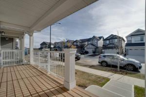 a porch of a house with a car parked on it at LovelyHome-Foosball-NearAirport-5 Queen Beds -Air conditioning in Edmonton
