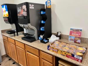 a counter with a coffee machine and a box of donuts at Presidio Parkway Inn in San Francisco