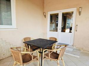 a black table and chairs on a patio at Hestia Apartments in Rovinj