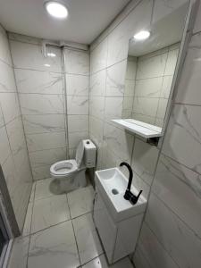 a bathroom with a toilet and a sink and a mirror at URAZ SuiT in Bursa