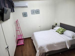 1 dormitorio con cama blanca y escalera rosa en Gywel en San Salvador
