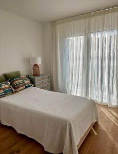 a bedroom with a bed and a large window at Villa Emerald Oeiras Lisbon in Oeiras