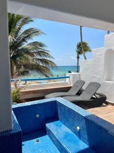 a view of the beach from a resort with blue tiles at Pelicano Inn Playa del Carmen - Beachfront Hotel in Playa del Carmen
