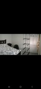 a bedroom with a bed and a ladder in a room at S&M Apartments and rooms in San José