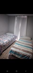 a bedroom with two beds sitting next to each other at S&M Apartments and rooms in San José