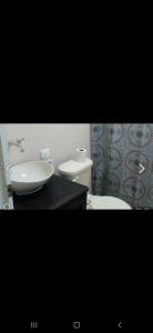 a bathroom with a sink and a toilet at S&M Apartments and rooms in San José