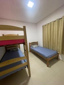 a room with two bunk beds and a window at GREAT HOUSE in Manaus