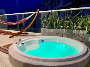 a hot tub on a balcony with a hammock at Dominique By Stay Q in Cartagena de Indias