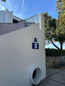 a white wall with a number on it at Apartments with parking space Gajac, Pag - 22921 in Novalja