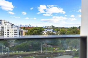 a view from a window of a city with a train at Spacious 2Bedroom Apt in Homebush in Sydney
