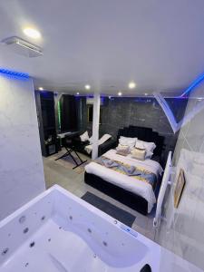 a bedroom with a bed and a bath tub at Room & Jacuzzi - Stade de France in Saint-Denis
