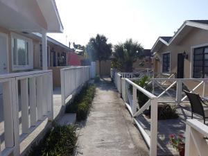 a white fence in front of some houses at Sarah's Haven in Nassau