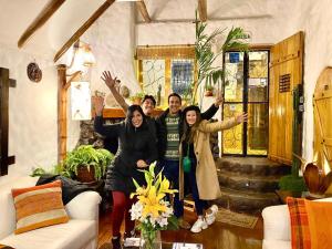 a group of people standing in a living room at Hostal Madre Tierra in Cusco