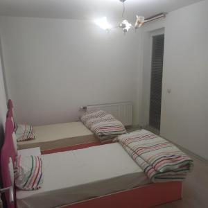 2 camas en una habitación pequeña con ventana en URBAN 1 Ferizaj City, en Ferizaj