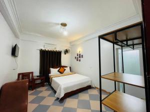 a bedroom with a bed and a desk and a chair at Thắng Lợi Hotel in Thanh Hóa