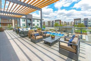 an outdoor patio with couches and a pool at Ft Worth 1BR Luxury Retreat in Fort Worth
