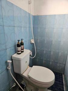 a bathroom with a toilet with two bottles on it at Mel's Place 2BR Apartment Unit2 in Batangas City in Batangas City