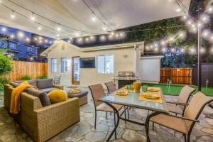 a living room with a couch and a table at Modern Cottage, Hot Tub, Bistro Patio, Putting Green, Walk to All! in Thousand Oaks