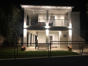 a house with lights on the front of it at night at THE WAVE HOUSE in Skala Sotiros