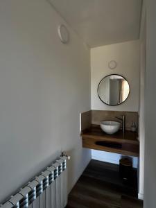 a bathroom with a sink and a mirror at Casa Raíz Cumbrecita in La Cumbrecita