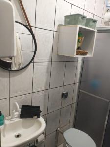 a bathroom with a toilet and a sink and a mirror at Hostel 940 in Sinop