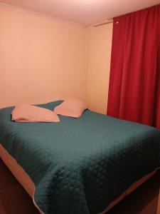 een slaapkamer met een bed met een rood gordijn bij Portal del Centro in Concepción