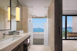 a bathroom with a view of the ocean at Lampung Marriott Resort & Spa in Lampung