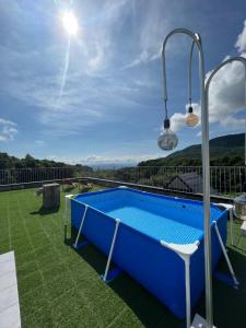 a blue swimming pool on the roof of a house at Matsukaneya Annex in Zao Onsen +54 photos