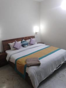 uma cama grande com almofadas num quarto em Hotel Marina Hills em Solan