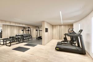 a gym with treadmills and machines in a room at Hotel Grand Bach Atami Crescendo in Atami