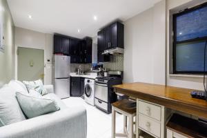 a kitchen with a couch and a table in a room at Park Side Living, City Style in New York