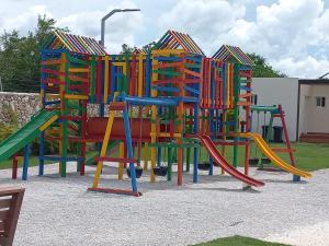 a colorful playground with a colorful play structure at Pool View Punta Cana in Punta Cana