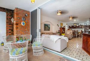 a living room with a couch and a brick wall at Playa Bonita in Puerto Vallarta