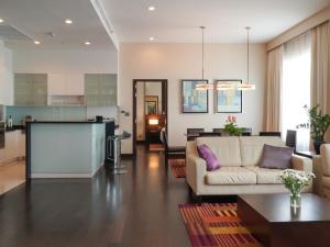 a living room with a couch and a table at Marriott Executive Apartments Sukhumvit Park, Bangkok in Bangkok