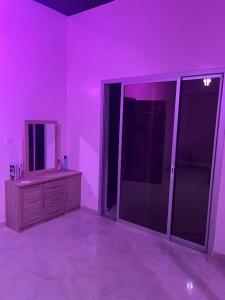 Cette chambre violette comprend une commode et un miroir. dans l'établissement Villa Dakar 200 m plage, à Dakar