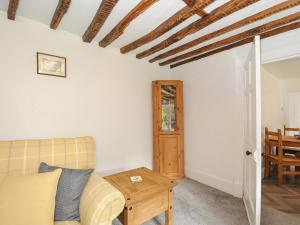 a living room with a couch and a table at Lee Barton Farmhouse in Bude