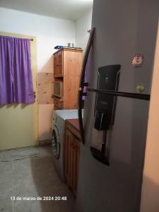 a kitchen with a refrigerator and a washing machine at Alquiler Jano in Tecka