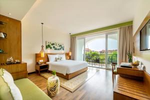 a bedroom with a bed and a balcony at Lasenta Boutique Hotel Hoian in Hoi An +89 photos