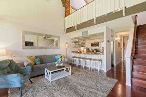 a living room with a couch and a table at Luana Kai Loft C308 BY Betterstay in Kihei