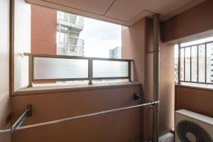 uma casa de banho com uma janela num edifício em CITYSPIRE Sakuragawa II em Osaka