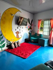 a living room with a crescent moon and a red rug at LUNA DEL DESIERTO TATACOA 2DA SEDE in Villavieja