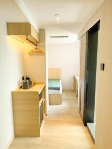 a small room with a desk and a bed at Urbanwood Hung Hom in Hong Kong